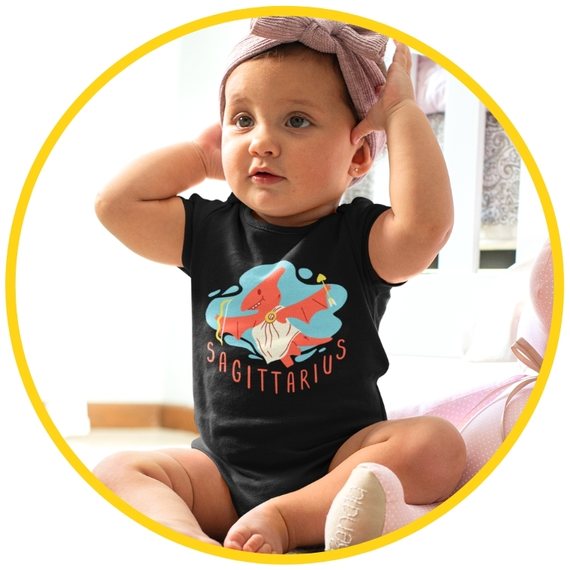 Image of a baby wearing a black Sagittarius zodiac-themed onesie sitting in a room